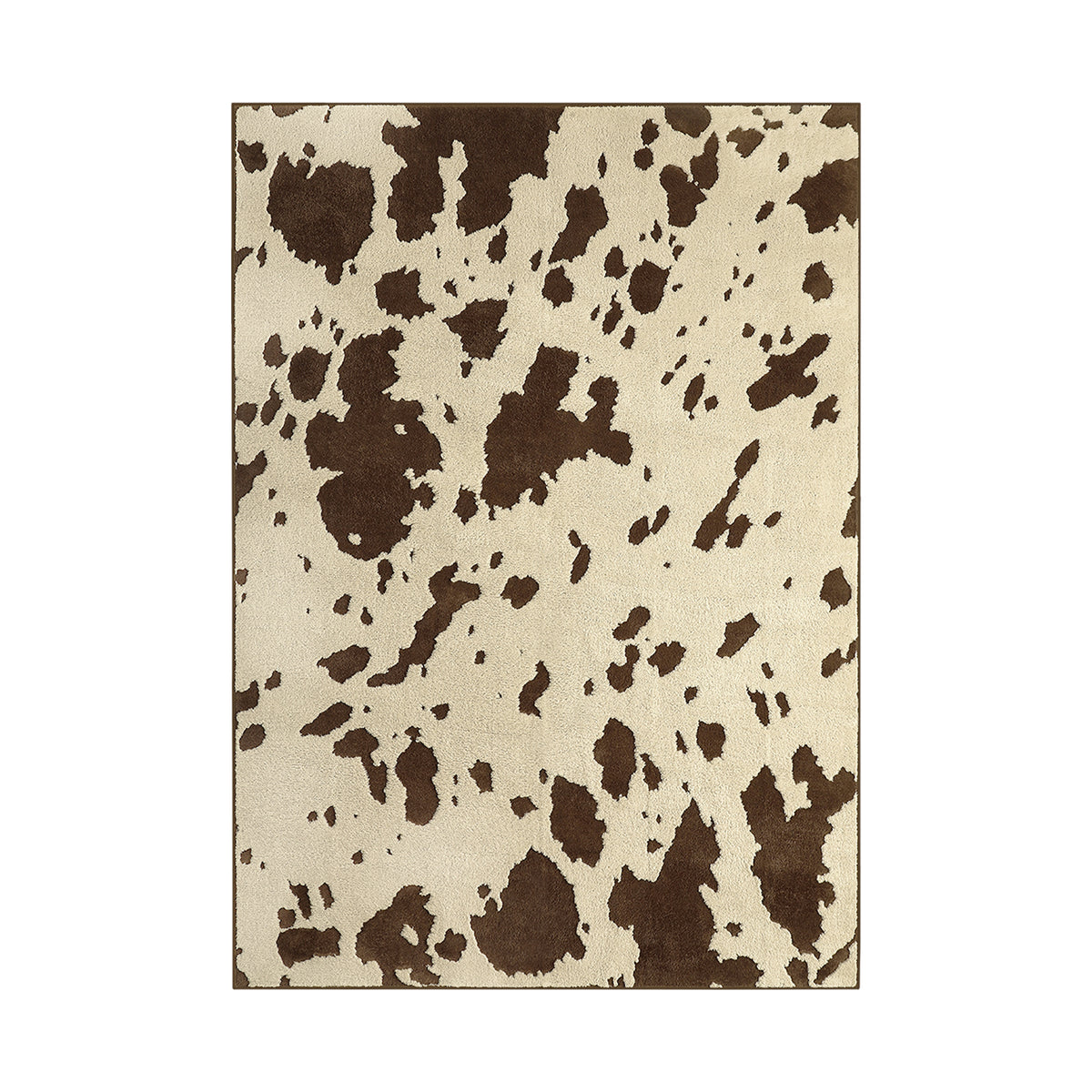 A rectangular area rug with a cow-print pattern featuring dark brown irregular spots on a warm cream background, shown flat against a white background.